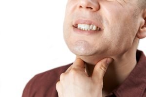 Close up of man suffering with sore throat