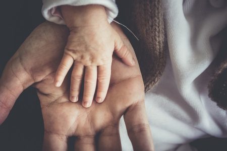 Child Hand on Adult Hand