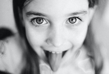 The Best Mewing Practices to Enhance Your Jawline Girl tongue sticking out of her mouth