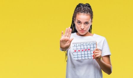 African american girl holding menstruation calendar