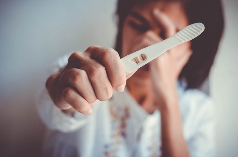 Woman Holding Pregnancy Test Kit