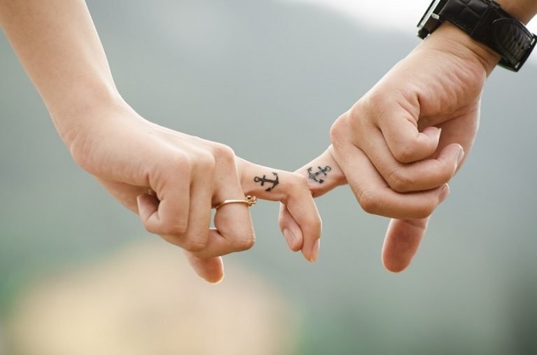How to Support a Partner Struggling With Infertility: Tips for Couples couple hands fingers