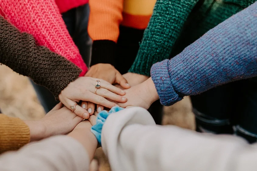 Girl friends hands piled togethger