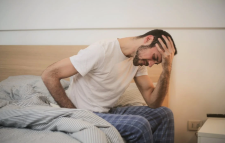 Young man experiencing headache and stress while recovering after a car accident