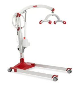 Caregiver using a patient lift device to safely transfer a patient from bed to wheelchair in a healthcare setting