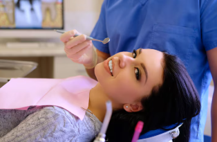 Dentist restoring a damaged tooth using biomimetic bonding technique instead of placing a dental crown