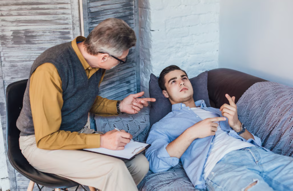 Trauma-informed coach supporting client in calm, safe space focused on nervous system regulation and emotional healing.