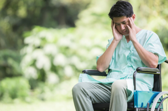 Person sitting alone in dim light symbolizing severe depression and mental health disability support