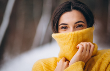 Austin woman applying moisturizer during winter to prevent dry skin caused by low humidity and cold weather