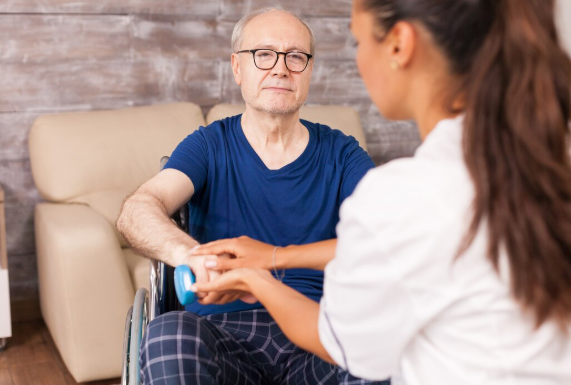 Parkinson’s disease patient doing light exercise with caregiver support to improve mobility and daily functioning.