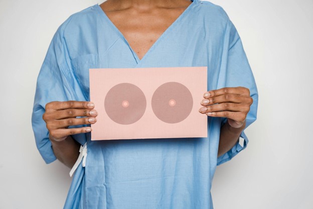 Clinical Overview of Breast Enhancement Surgery in Toronto Female patient consulting plastic surgeon about breast augmentation options and implant choices in a clinical setting.