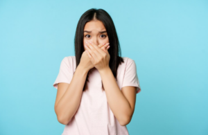 Person holding jaw in pain at home during a dental emergency, searching for a Sunday dentist for urgent care.