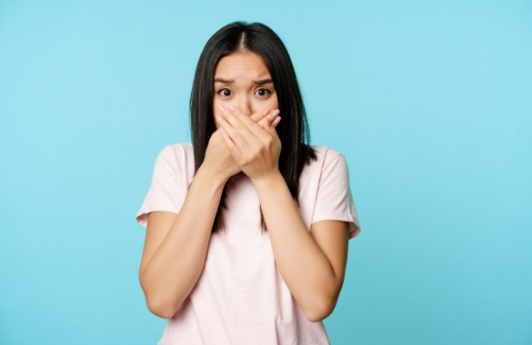 Person holding jaw in pain at home during a dental emergency, searching for a Sunday dentist for urgent care.