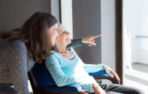 How Seeking Alzheimer’s Resources Can Empower Caregivers Caregiver assisting an elderly Alzheimer’s patient at home with emotional support and daily care activities.