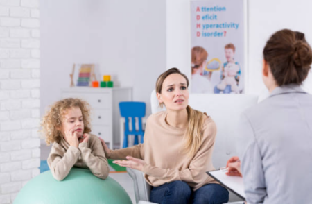 Child with autism engaging in ABA therapy session with therapist using interactive learning tools.