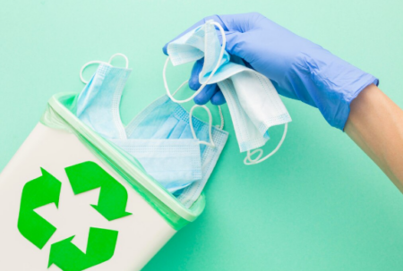 Color-coded medical waste bins for infectious, sharps, and pharmaceutical disposal in a healthcare facility.