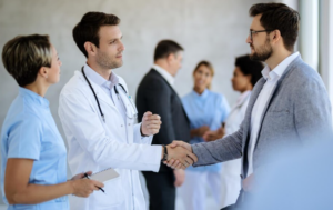 Enhancing Patient Experience Through Effective Healthcare Leadership Healthcare leader discussing patient care strategies with medical staff to improve patient experience and quality of care.