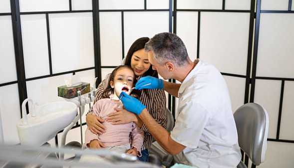 Parent helping a child prepare for dental visit to build confidence and reduce anxiety.