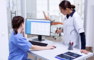 Doctor using healthcare practice management system on computer