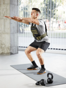 What Are the Benefits of a Weighted Vest? Person working out outdoors wearing a weighted vest for fitness training and endurance exercise.