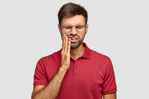 Illustration of a person in pain due to a dental abscess showing infected tooth root