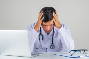 Busy hospital emergency room with doctors and nurses treating patients, highlighting risks of ER errors and triage decisions