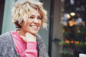 7 Tips to Help Women Stay Healthy Over Time Smiling healthy woman practicing healthy lifestyle habits including hydration, fitness, sleep, and self-care for overall wellness