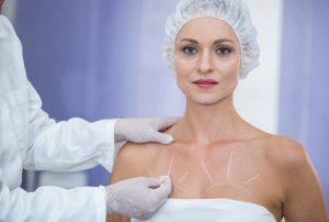 What Breast Fat Grafting Is and How the Procedure Actually Works Plastic surgeon discussing breast fat grafting procedure with a patient seeking natural breast enhancement.