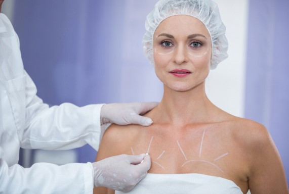 Plastic surgeon discussing breast fat grafting procedure with a patient seeking natural breast enhancement.