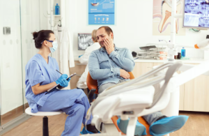 Common Dental Emergencies Treated in Dana Point Emergency dentist treating a patient with severe tooth pain and dental infection