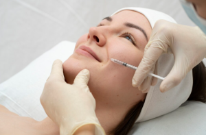 Woman receiving dermal filler treatment for subtle facial rejuvenation and volume restoration