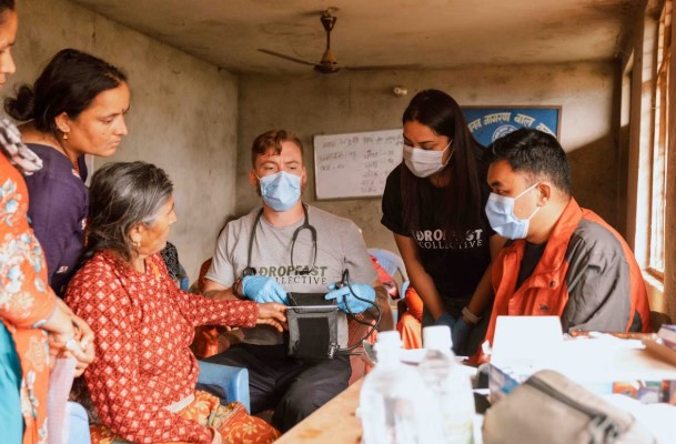 Nurse providing hospital-level medical care to a patient recovering at home using remote monitoring technology.