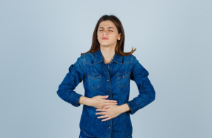 Person experiencing bloating and digestive discomfort associated with leaky gut symptoms