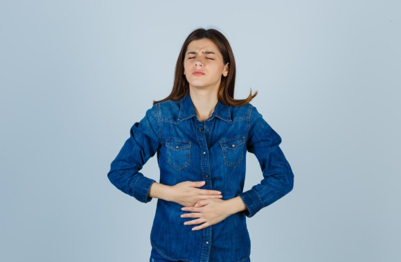 Person experiencing bloating and digestive discomfort associated with leaky gut symptoms