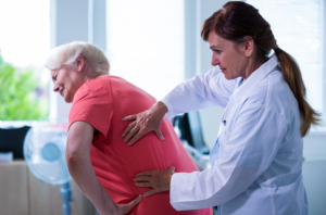 How Physical Therapy Helps Lower Back Pain Recovery Physical therapist guiding patient through lower back pain rehabilitation exercises