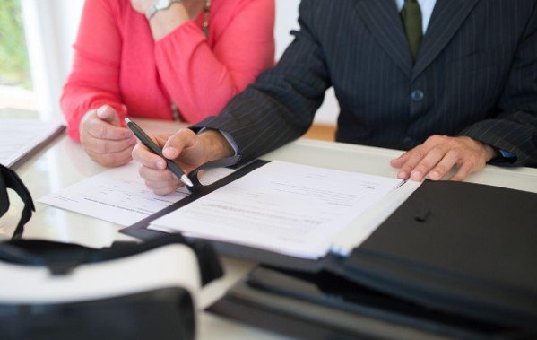 Hospital patient recovering from severe stroke while family discusses medical malpractice and legal options with an attorney.