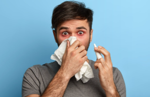 Do Nasal Strips Help With Snoring From Nasal Congestion? Person experiencing nasal congestion during bedtime affecting snoring.
