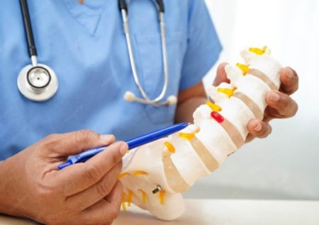 5 Signs that Make You a Good Candidate for Herniated Disc Treatment Spine specialist reviewing a disc model with a patient