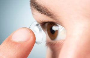 performing a contact lens exam and fitting trial contact lenses for a first-time patient during an eye examination.