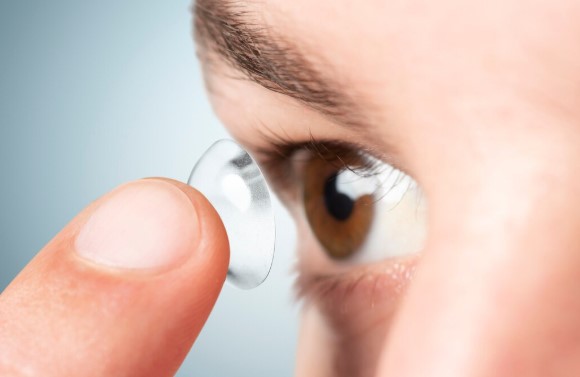 performing a contact lens exam and fitting trial contact lenses for a first-time patient during an eye examination.