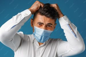 Person noticing increased hair shedding while brushing their hair after recovering from COVID-19.