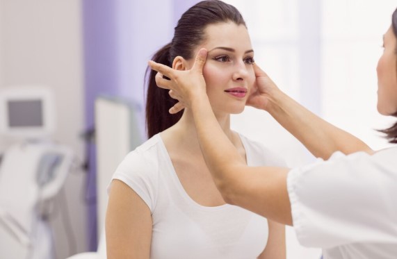 Plastic surgeon consulting with a patient about facelift surgery and facial rejuvenation.