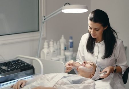 Aesthetic professional performing a medical-grade skincare treatment in a medspa setting.