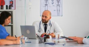 How to Know If You Have a Valid Medical Malpractice Claim After a Hospital Mistake Medical malpractice attorney reviewing hospital records with a client after a suspected hospital error.