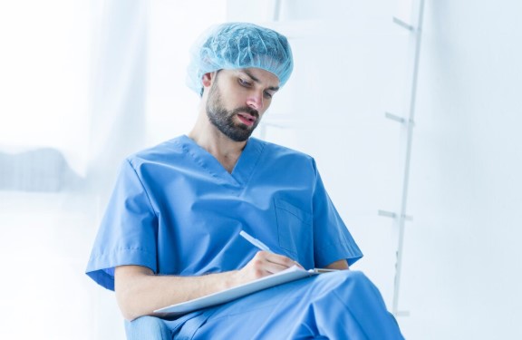 Physician using an AI medical scribe to document a patient consultation while maintaining eye contact during the visit.