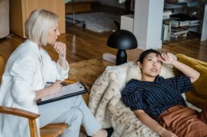 The Real Reason You’re Working Weekends (Hint: It’s Not the Patients) Psychologist with patient to complete notes, scheduling, and billing in a modern clinic.
