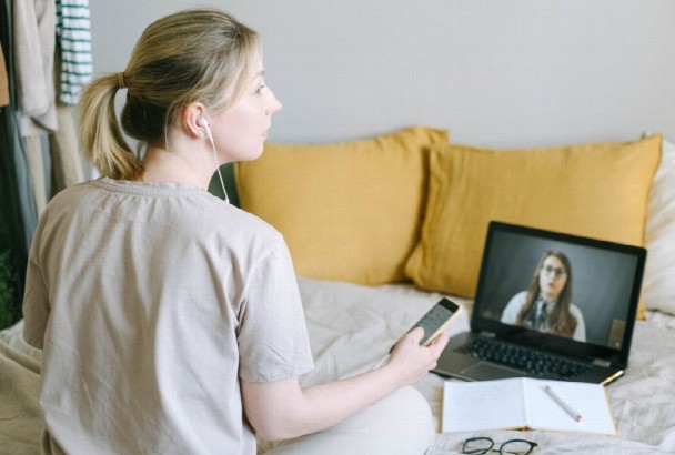 Person attending a virtual addiction treatment counseling session from home.