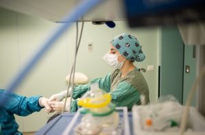 Anesthesia technology student practicing surgical equipment preparation and anesthesia support skills in a clinical training laboratory.
