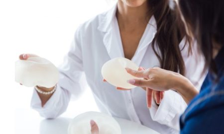 Woman discussing breast reduction surgery options and expected results with a plastic surgeon during a consultation.
