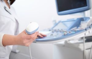 How Ultrasound Technology Has Transformed Modern Healthcare Healthcare professional performing an ultrasound examination using a transducer to create real-time diagnostic images.